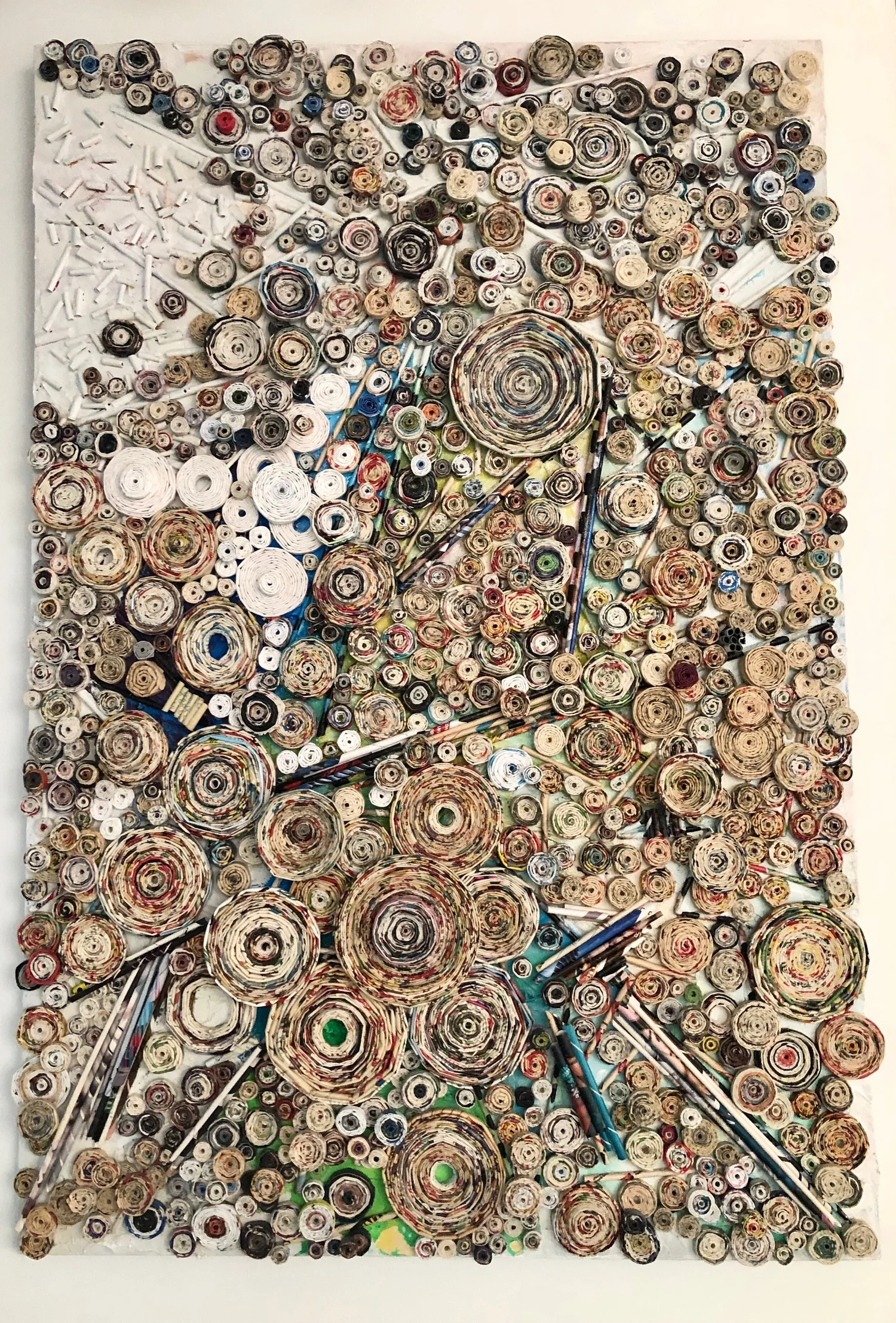 A dimensional mixed-media artwork composed of tightly rolled paper spirals